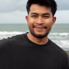 front-view-smiley-man-seaside_23-2149737022